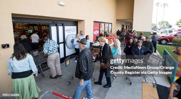 Shoppers enter the Grocery Outlet Bargain Market on Beach Blvd. In Huntington Beach, CA during the opening of the store on Thursday, March 29, 2018....