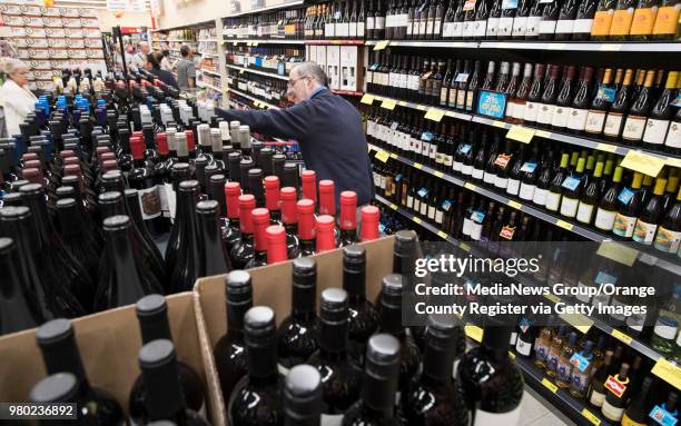 Shoppers look over the wine selections at the Grocery Outlet Bargain Market on Beach Blvd. In Huntington Beach, CA during the opening of the store on...