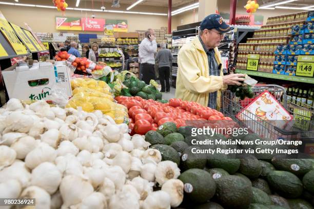 Shopper picks out produce during the opening of the Grocery Outlet Bargain Market opening on Beach Blvd. In Huntington Beach, CA on Thursday, March...