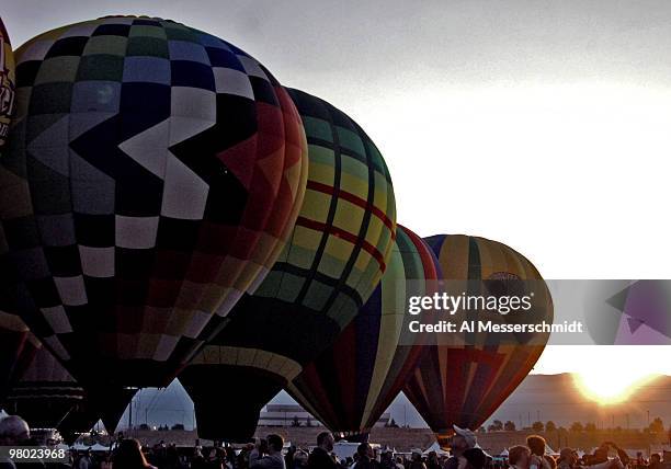 Hot air balloons launch at sunrise for during a morning ascent at the Albuquerque International Balloon Fiesta in Albuquerque, New Mexico on October...