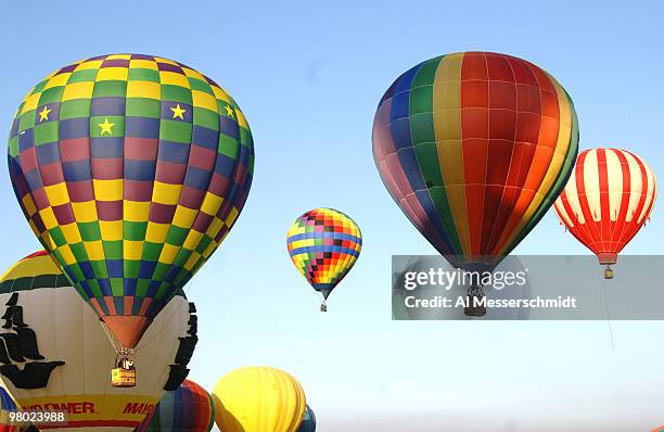 Hot air balloons fly overhead during a morning ascent at the Albuquerque International Balloon Fiesta in Albuquerque, New Mexico on October 8, 2005.