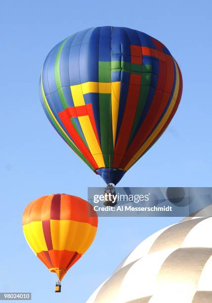 Hot air balloons fly overhead during a morning ascent at the Albuquerque International Balloon Fiesta in Albuquerque, New Mexico on October 8, 2005.