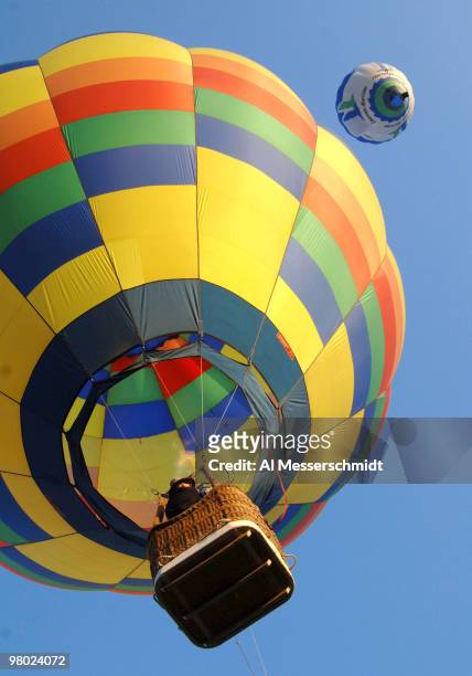 Hot air balloons fly overhead during a morning ascent at the Albuquerque International Balloon Fiesta on October 8, 2005.