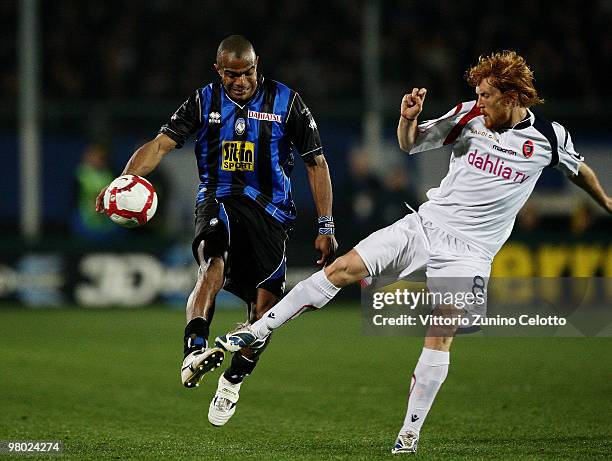 Adriano Ferreira Pinto of Atalanta BC competes for the ball with Davide Biondini of Cagliari Calcio during the Serie A match between Atalanta BC and...