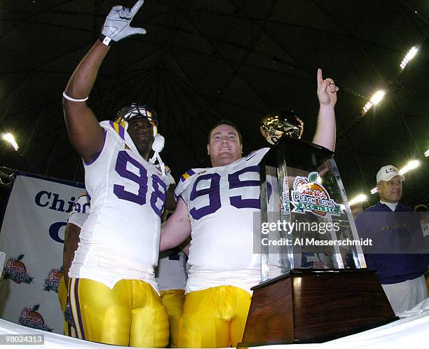Defenders Claude Wroten and Kylke Williams celebrate a victory over the University of Miami at the 2005 Chick-fil-A Peach Bowl at the Georgia Dome in...