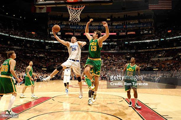 Hedo Turkoglu of the Toronto Raptors glides for the layup defended by Mehmet Okur of the Utah Jazz during a game on March 24, 2010 at the Air Canada...