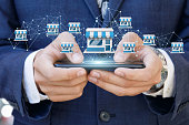 Businessman showing Franchise system on a mobile .