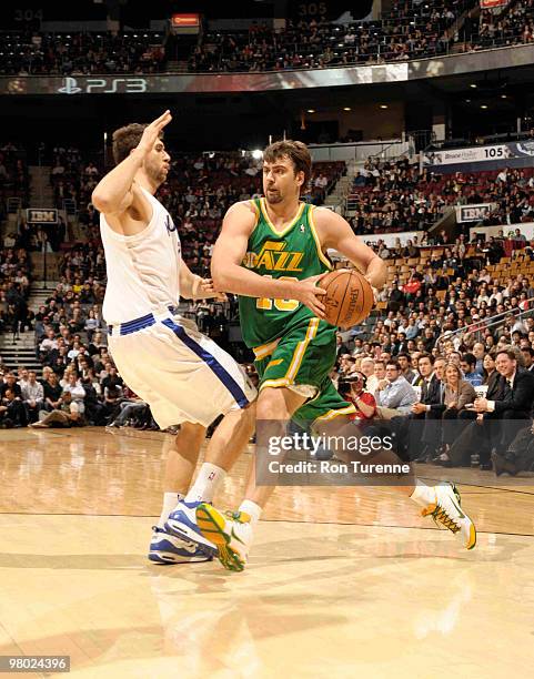 Mehmet Okur of the Utah Jazz looks to get past defender Andrea Bargnani of the Toronto Raptors during a game on March 24, 2010 at the Air Canada...