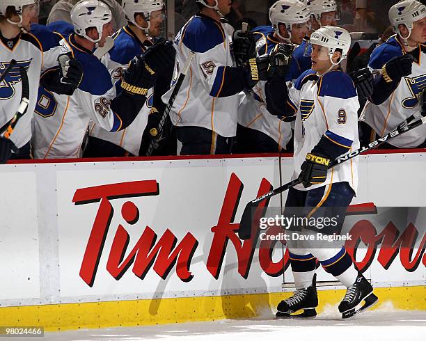 Paul Kariya of the St. Louis Blues is congratulated by teammates for his goal against the Detroit Red Wings during an NHL game at Joe Louis Arena on...