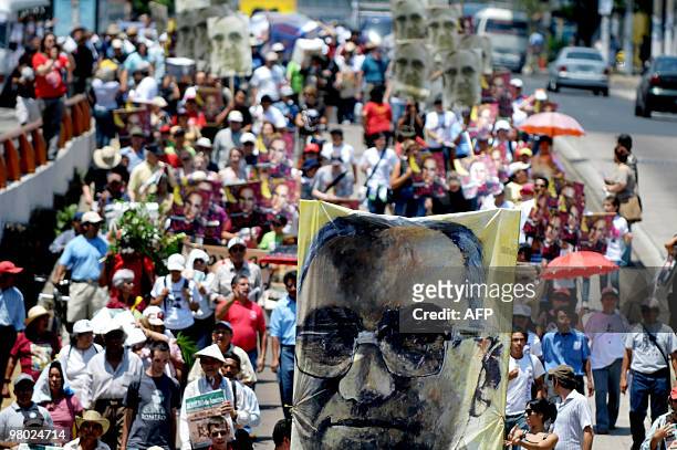 People march on March 24, 2010 in San Salvador during the commemoration of the 30th anniversary of the murder of Monsignor Oscar Arnulfo Romero, who...