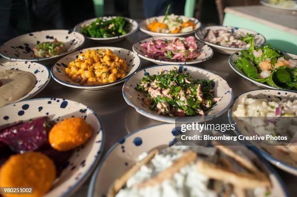 dishes of cold meze are served at a restaurant - israel food stock pictures, royalty-free photos & images