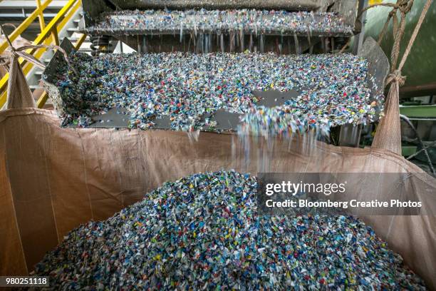 plastic bottle waste is shredded at a facility - picotado - fotografias e filmes do acervo