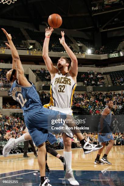 Josh McRoberts of the Indiana Pacers shoots over James Singleton of the Washington Wizardsat Conseco Fieldhouse on March 24, 2010 in Indianapolis,...