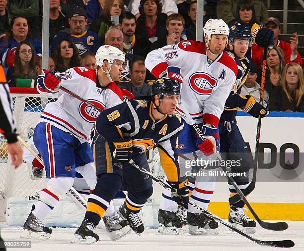 Derek Roy and Thomas Vanek of the Buffalo Sabres battle for position against Josh Gorges and Hal Gill of the Montreal Canadiens on March 24, 2010 at...