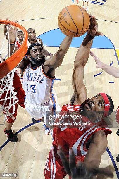 James Harden of the Oklahoma City Thunder grabs a rebound away from Mike Harris of the Houston Rockets during the game at the Ford Center on March...