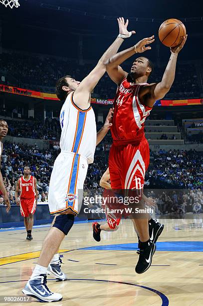 Chuck Hayes of the Houston Rockets goes to the basket against Nenad Krstic of the Oklahoma City Thunder during the game at the Ford Center on March...