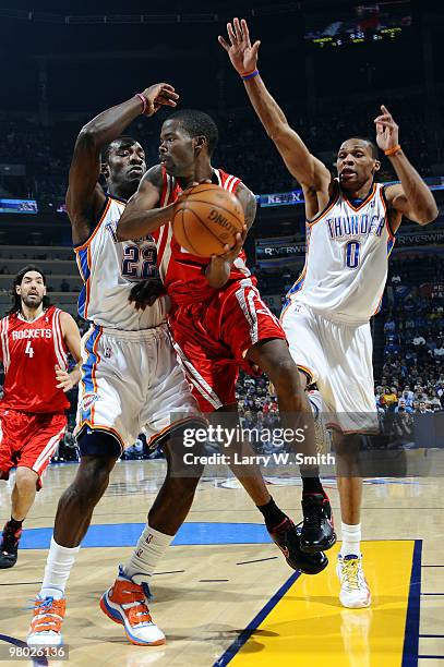 Aaron Brooks of the Houston Rockets goes to the basket against Jeff Green and Russell Westbrook of the Oklahoma City Thunder during the game at the...