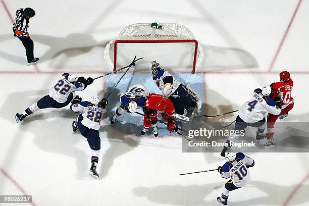 Todd Bertuzzi of the Detroit Red Wings scores as Brad Boyes, Carlo Colaiacovo and Ty Conklin of the St. Louis Blues try to stop the puck during an...