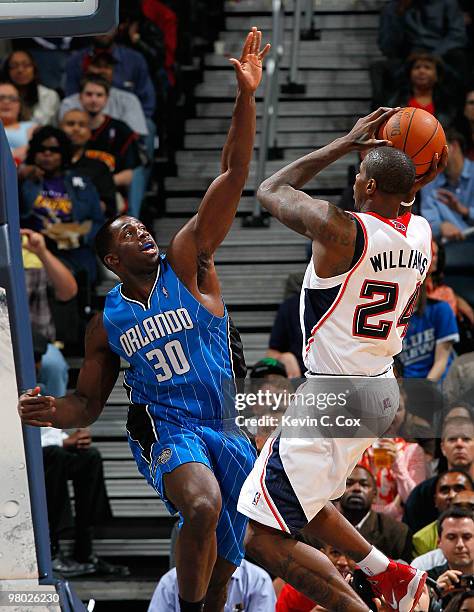 Marvin Williams of the Atlanta Hawks shoots against Brandon Bass of the Orlando Magic at Philips Arena on March 24, 2010 in Atlanta, Georgia. NOTE TO...