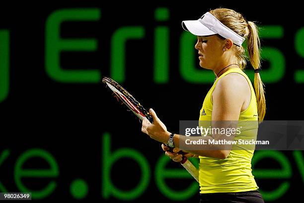 Melanie Oudin of the United States adjust her racquet against Michaella Krajicek of the Netherlands during day two of the 2010 Sony Ericsson Open at...