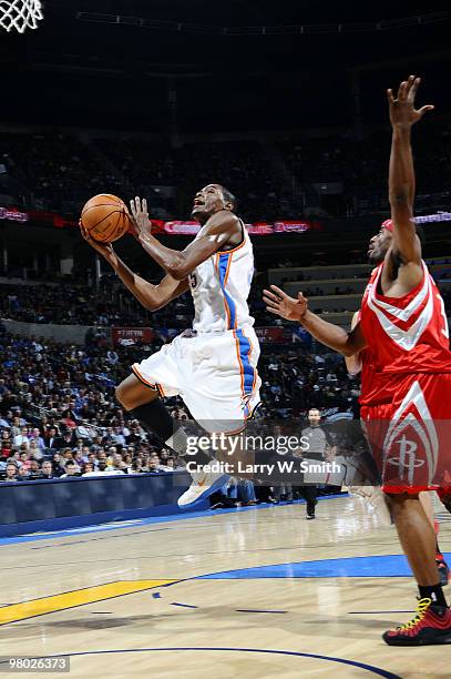 Kevin Durant of the Oklahoma City Thunder goes to the basket against Mike Harris# of the Houston Rockets during the game at the Ford Center on March...