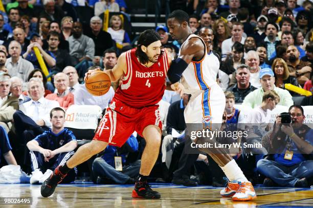 Luis Scola of the Houston Rockets drives to the basket against Jeff Green of the Oklahoma City Thunder during the game at the Ford Center on March...