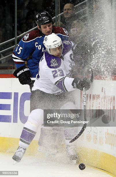 Dustin Brown of the Los Angeles Kings and Cody McLeod of the Colorado Avalanche collide with the boards as they vie for the puck during NHL action at...