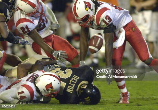 Louisville defenders strip the football from Wake Forest fullback Rich Belton on January 2, 2007 at the 73rd annual FedEx Orange Bowl in Miami,...