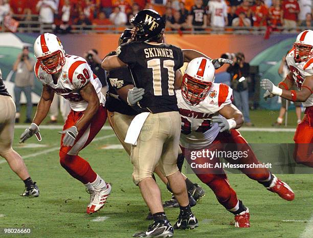 Louisville defensive tackle Adrian Grady hits Wake Forest quarterback Riley Skinner Jan. 2, 2007 in the 73rd annual FedEx Orange Bowl in Miami....