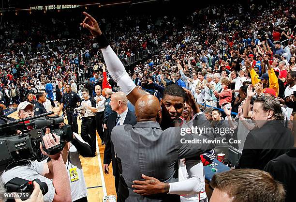 Josh Smith of the Atlanta Hawks celebrates with head coach Mike Woodson after dunking the game-winning basket against the Orlando Magic at Philips...