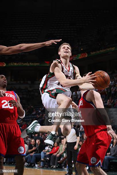 Luke Ridnour of the Milwaukee Bucks shoots a layup against Jodie Meeks and Jason Smith of the Philadelphia 76ers on March 24, 2010 at the Bradley...