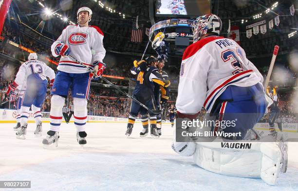 Steve Montador of the Buffalo Sabres celebrates with teammate Jochen Hecht after scoring the game-tying goal past Carey Price of the Montreal...
