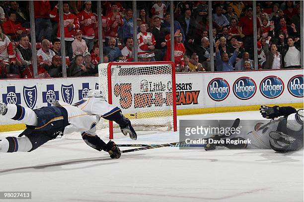 Oshie of the St. Louis Blues and teammate Carlo Colaiacovo fall to the ice as they try to stop the open net goal scored by Valtteri Filppula the...