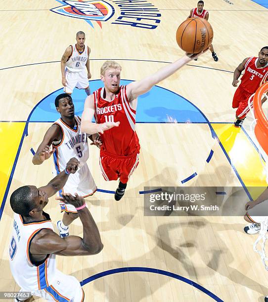 Chase Budinger of the Houston Rockets goes to the basket against Serge Ibaka and Kyle Weaver of the Oklahoma City Thunder during the game at the Ford...