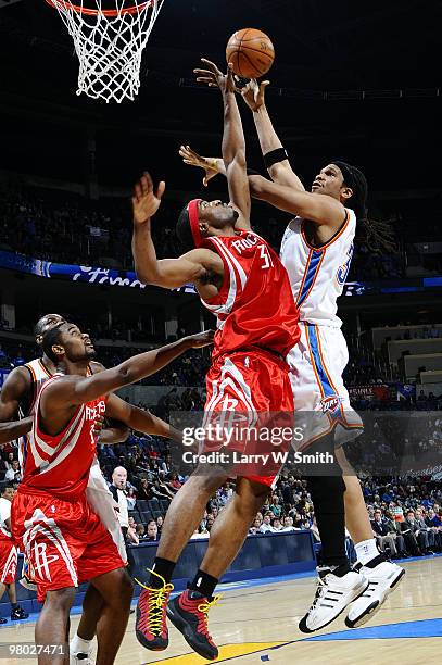 Etan Thomas of the Oklahoma City Thunder goes to the basket against Mike Harris of the Houston Rockets during the game at the Ford Center on March...