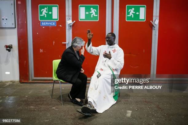 Priest blesses a person before the mass celebrated by the Pope during his one-day visit at the invitation of the World Council of Churches on June...
