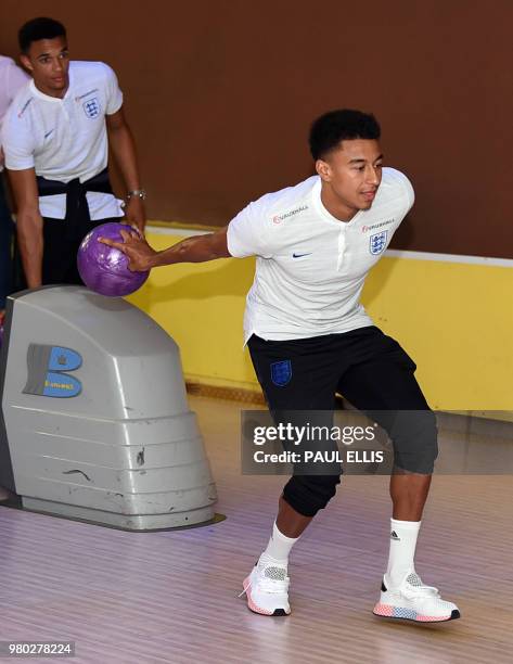 England's midfielder Jesse Lingard plays ten pin bowling at the media centre in Repino, Russia, on June 21 during the Russia 2018 World Cup football...