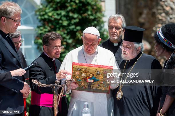 Pope Francis stands next to General Secretary of the World Council of Churches Olav Fykse Tveit, Swiss Cardinal Kurt Koch, his translator...
