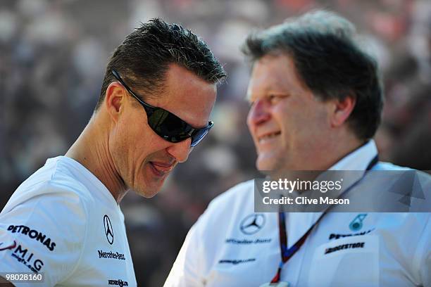 Michael Schumacher of Germany and Mercedes GP talks with Vice President of Mercedes Motorsport Norbert Haug in the paddock during previews to the...