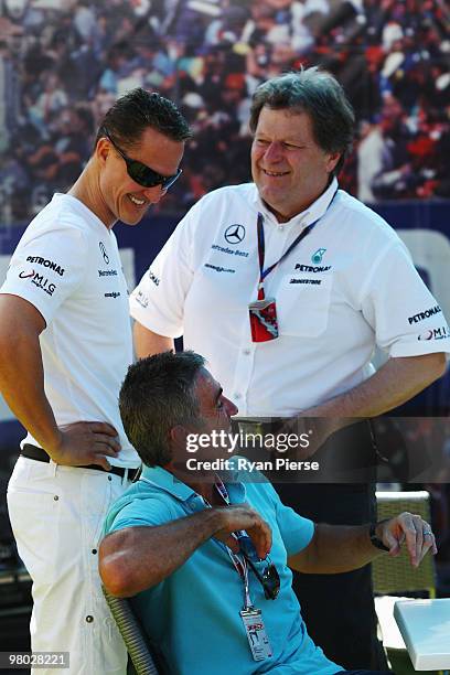 Michael Schumacher of Germany and Mercedes GP talks with Vice President of Mercedes Motorsport Norbert Haug and former motorcycle world champion Mick...