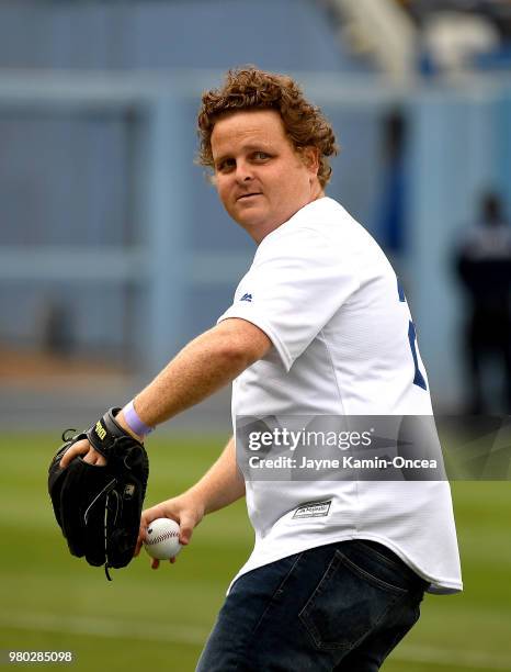 Actor Patrick Renna throws out the first pitch during a cast reunion of the "The Sandlot" to celebrate the movie's 25th anniversary before the game...