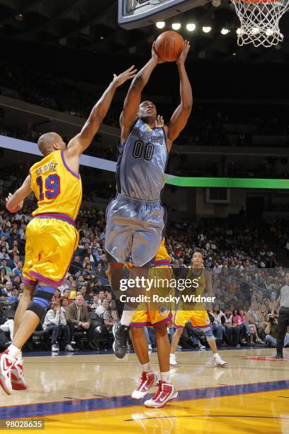 Darrell Authur of the Memphis Grizzlies attempts a layup against Devan George of the Golden State Warriors on March 24, 2010 at Oracle Arena in...