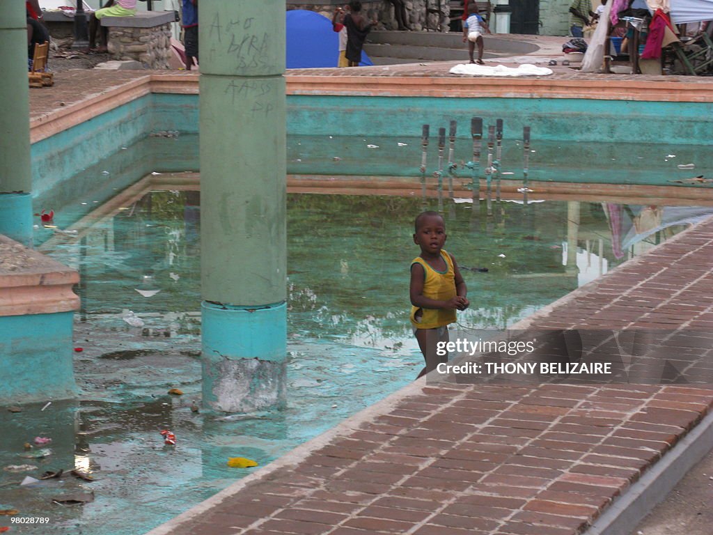 A young boy stands in the town square in