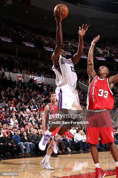 Tyreke Evans of the Sacramento Kings shoots a layup against Dante Cunningham of the Portland Trail Blazers during the game at The Rose Garden on...