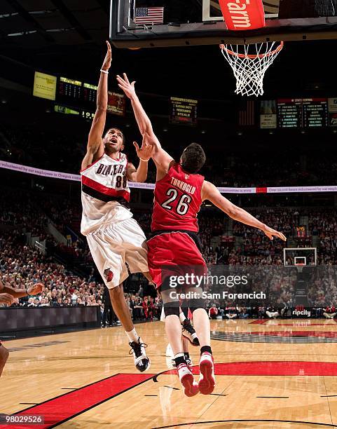 Nicolas Batum of the Portland Trail Blazers shoots a layup against Hedo Turkoglu of the Toronto Raptors during the game at The Rose Garden on March...