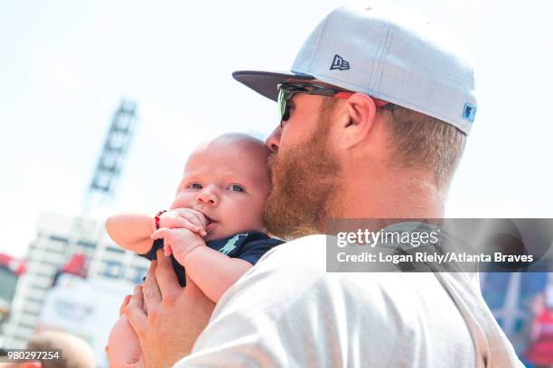 Mike Foltynewicz of the Atlanta Braves kisses his baby Jett before the game against the San Diego Padres at SunTrust Park on June 17 in Atlanta,...