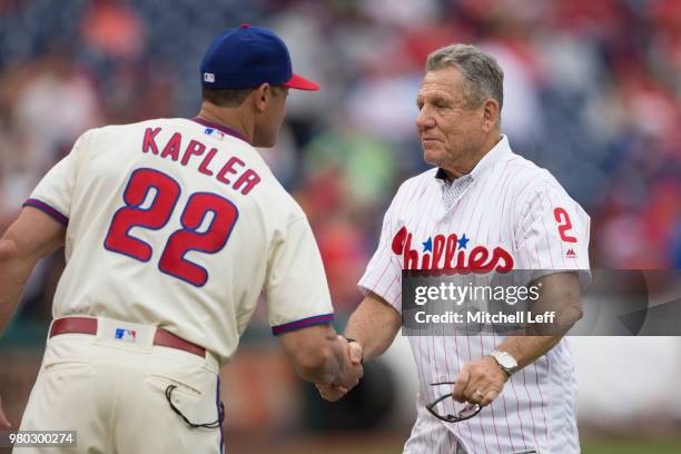 Manager Gabe Kapler of the Philadelphia Phillies shakes hands with former Philadelphia Phillies player Larry Bowa prior to the game against the...