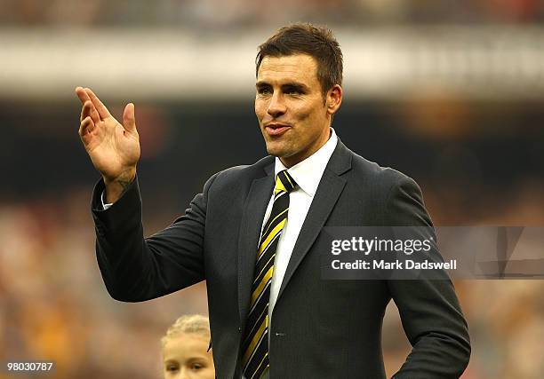 Former Club champion Matthew Richardson waves to the crowd as he walks through a guard of honour before the round one AFL match between the Richmond...