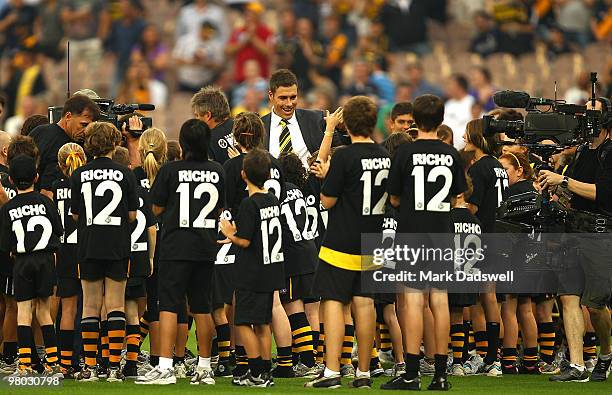 Former Club champion Matthew Richardson waves to the crowd as he walks through a guard of honour before the round one AFL match between the Richmond...