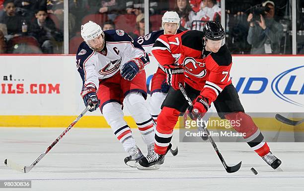 Paul Martin of the New Jersey Devils skates against Rick Nash of the Columbus Blue Jackets at the Prudential Center on March 23, 2010 in Newark, New...